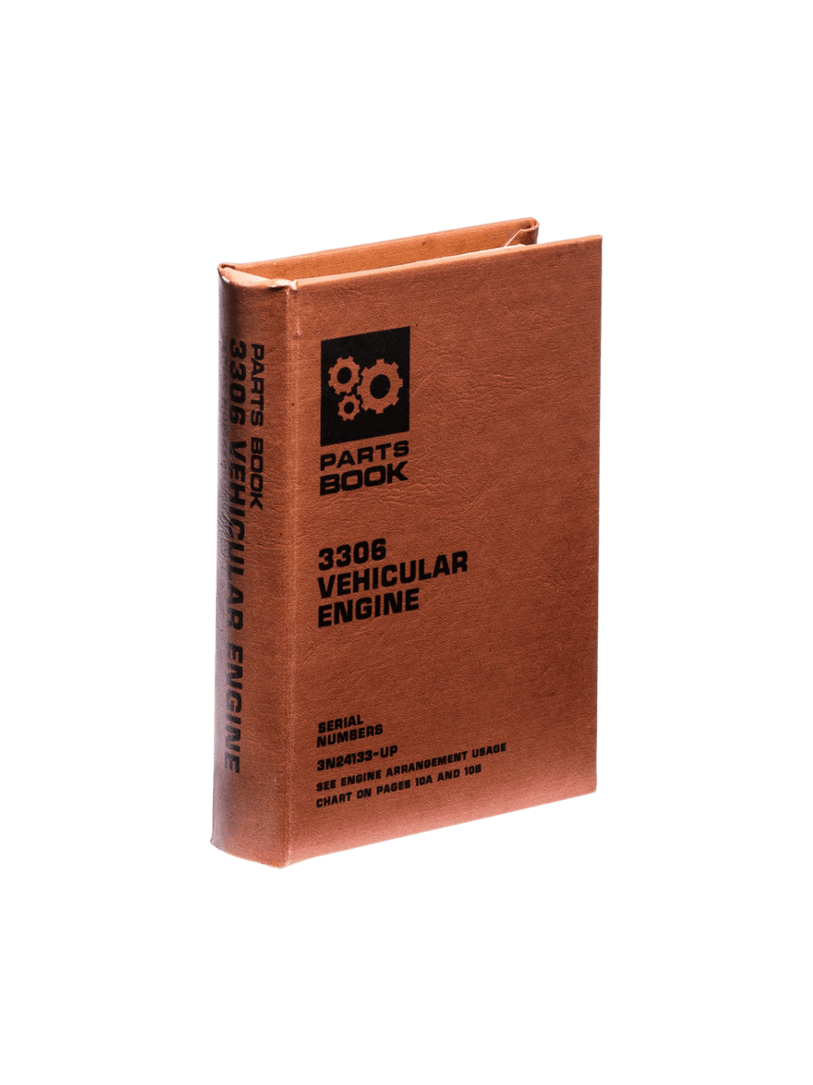 Brown Book Box - Vehicular Engine from Puebco stands upright, showcasing its vintage gear graphic and technical text printed on the front and spine | Twentyseven Toronto