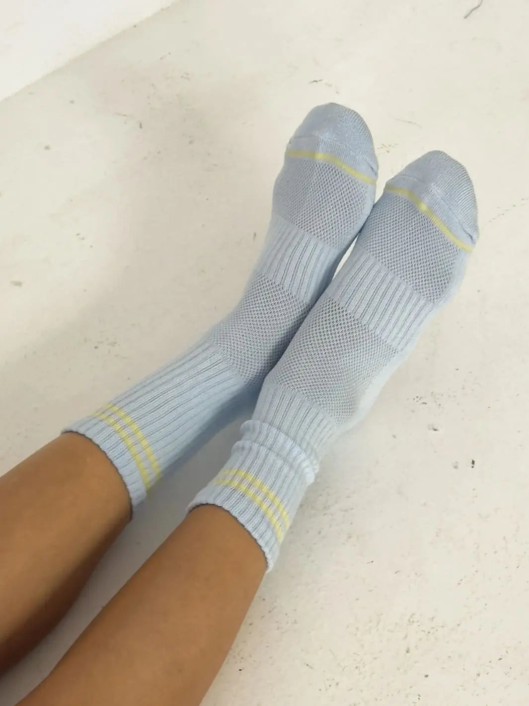 Light blue with yellow stripes Boyfriend Socks in 'Pastel Sky' worn by a person from Le Bon Shoppe on a light background | Twentyseven Toronto