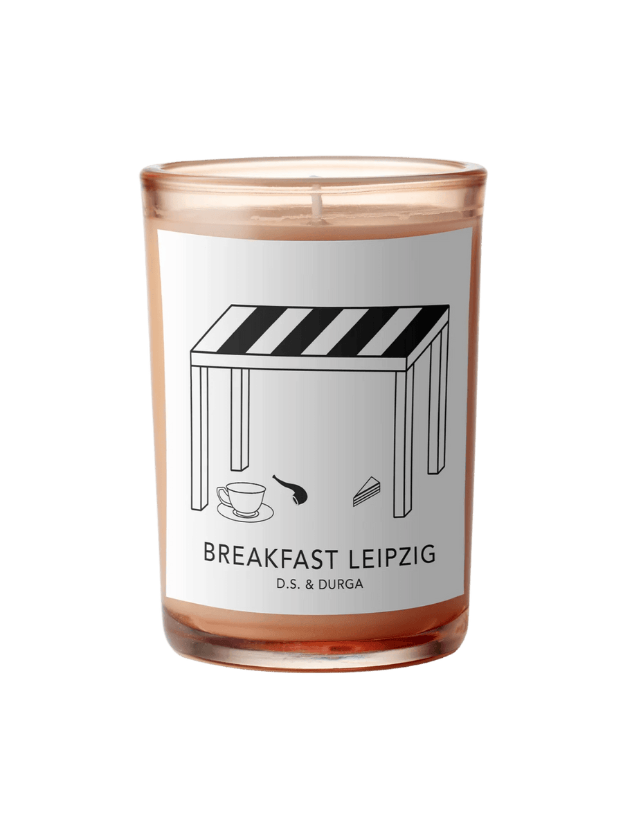 DS&Durga candle in an orange glass jar labeled 'Breakfast Leipzig' featuring cafe illustrations on a transparent background | Twentyseven Toronto