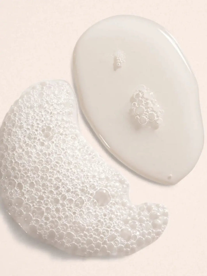 Two white product drops of Bubble Bath in Lavender + Vanilla by Beauty from Bees on a light pink background | Twentyseven Toronto