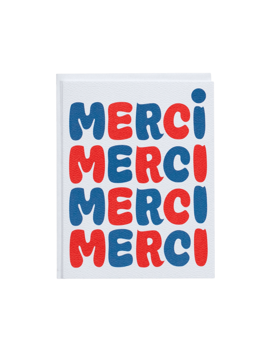 The Banquet Workshop Bubble Merci Note Card features the word "MERCI" repeated four times down the front in a bold, retro blue and red bubble font on a textured white card | Twentyseven