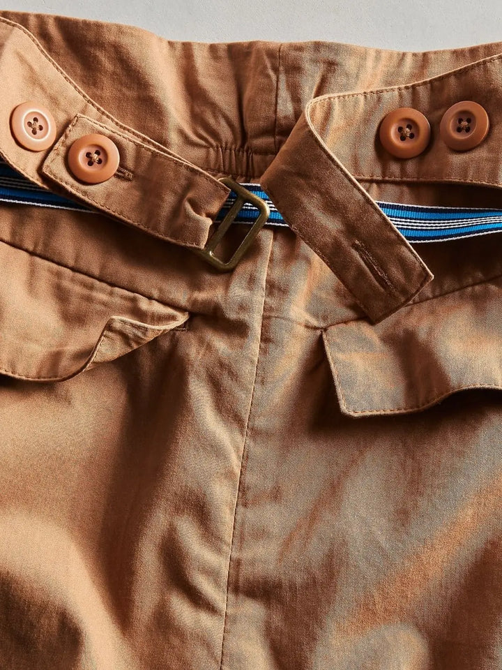 A close-up view of the back waistband highlights the adjustable tab detailing with buttons and a brass slide on the Free People Buckle Back Trousers - Tobacco Combo | Twentyseven Toronto