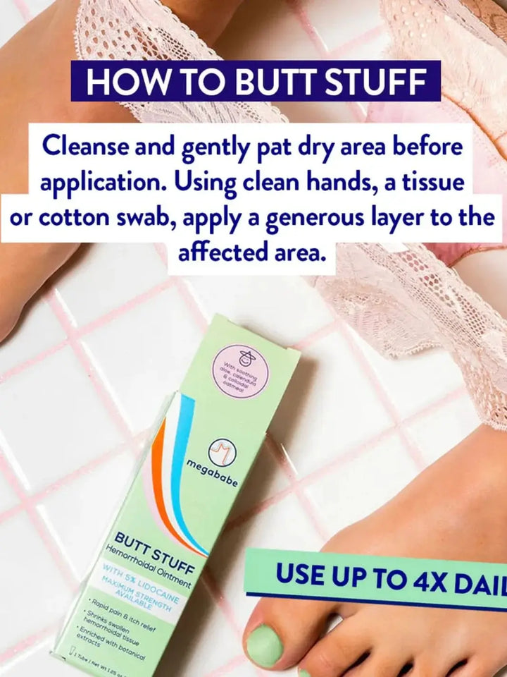 A green product carton is displayed alongside text detailing application instructions on a pink tiled surface, showcasing the usage steps for the Megababe Butt Stuff Hemorrhoid Cream | Twentyseven Toronto