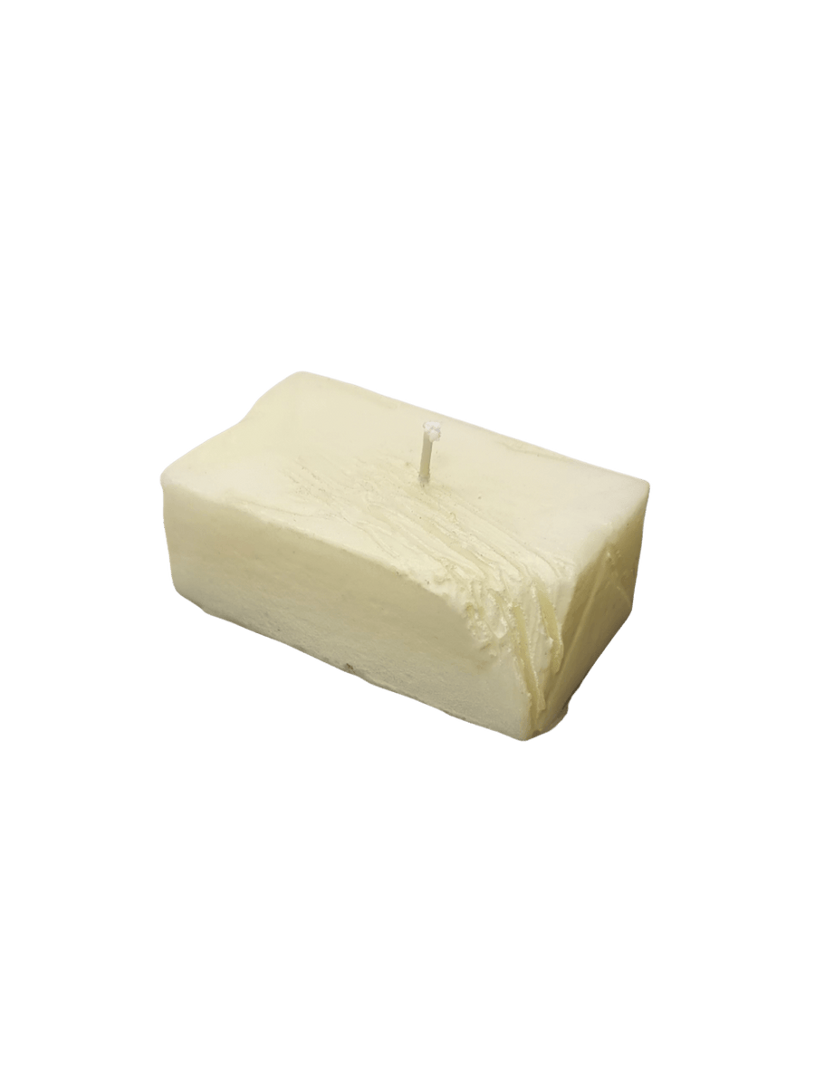 Candle in the shape of a block of butter from Cereria Introna on a transparent background | Twentyseven Toronto
