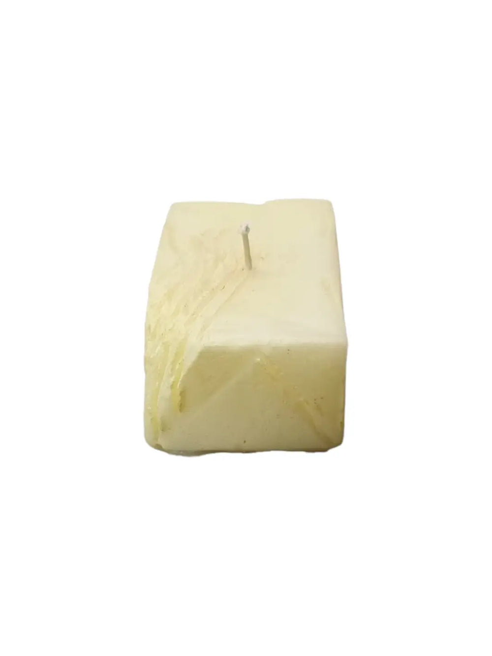 Candle in the shape of a block of butter from Cereria Introna on a white background | Twentyseven Toronto