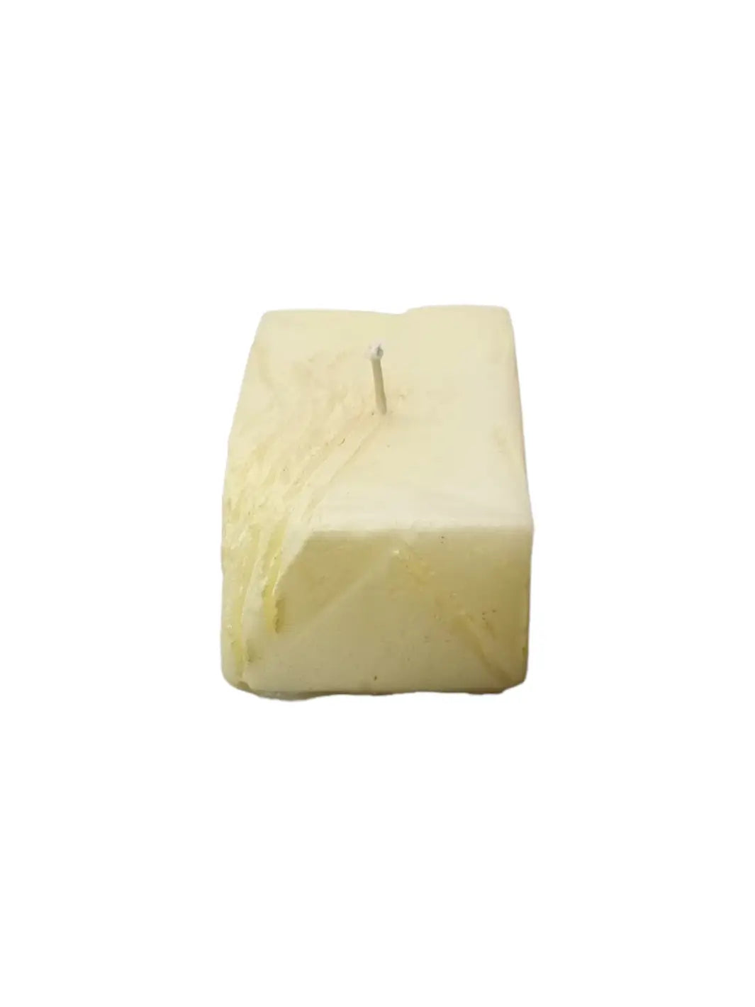 Candle in the shape of a block of butter from Cereria Introna on a white background | Twentyseven Toronto