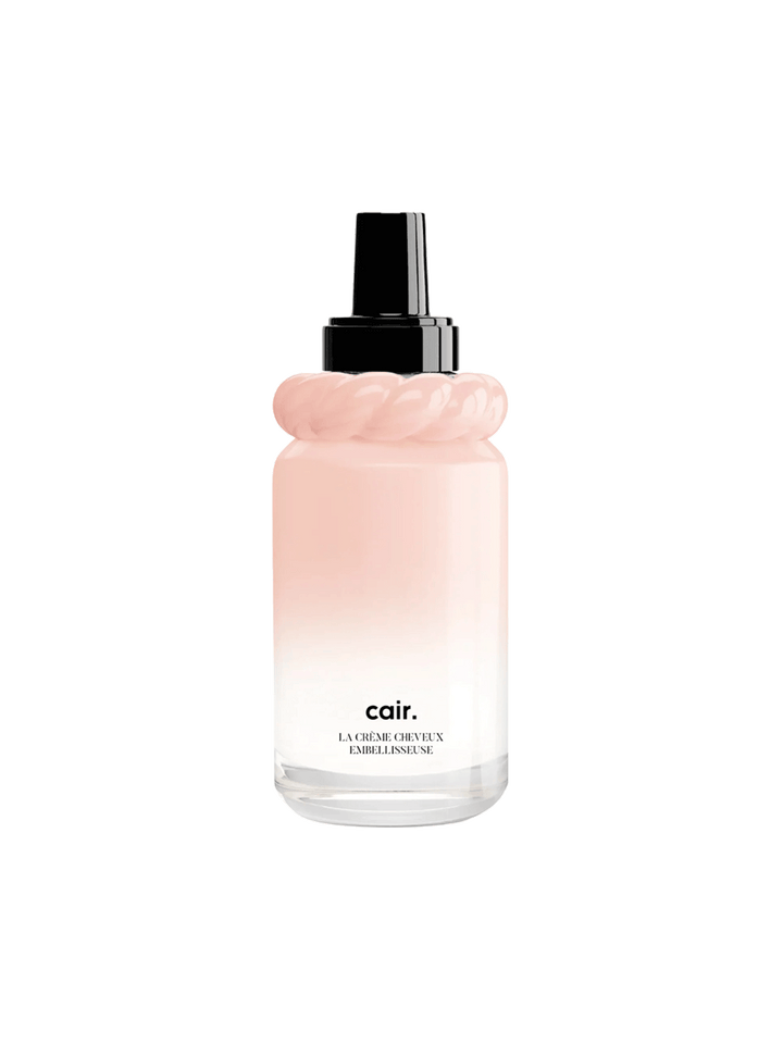 Cair Leave-In Hair Cream in a blush pink gradient bottle with sculptural neck detail and black pump on a white background | Twentyseven Toronto