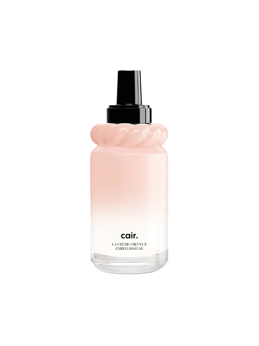 Cair Leave-In Hair Cream in a blush pink gradient bottle with sculptural neck detail and black pump on a white background | Twentyseven Toronto
