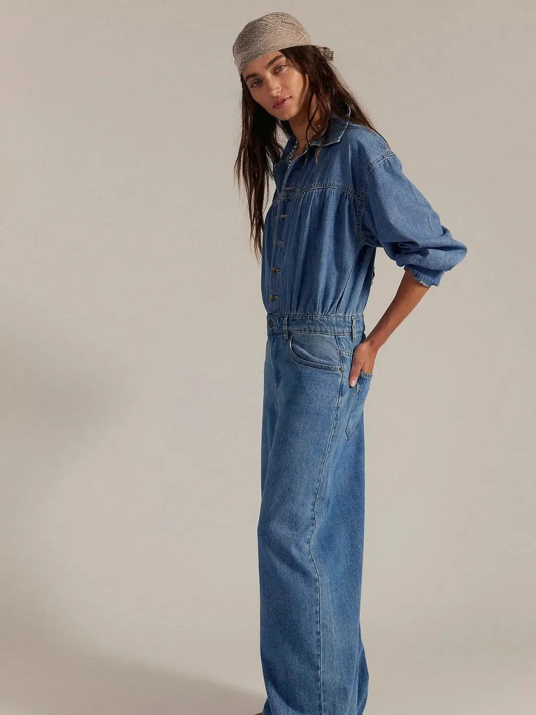 A side profile shot highlights the gathered elastic waistband, side pockets, and straight-leg silhouette of the Free People Carpe Diem One-Piece in New Day | Twentyseven Toronto