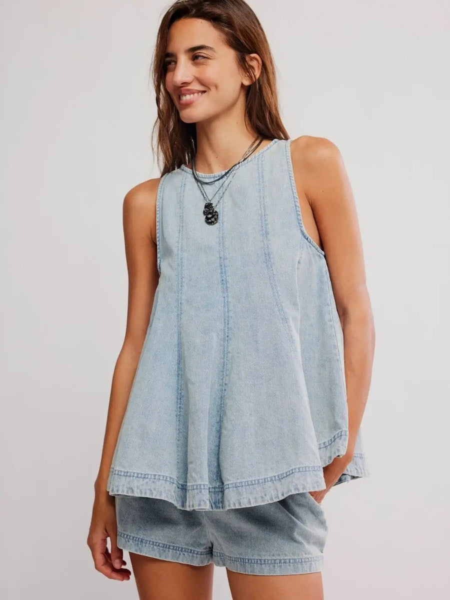 A classic studio front view shows the smiling model wearing the complete two-piece tank and shorts coordination of the Free People Cassius Denim Set in Bleachout | Twentyseven Toronto