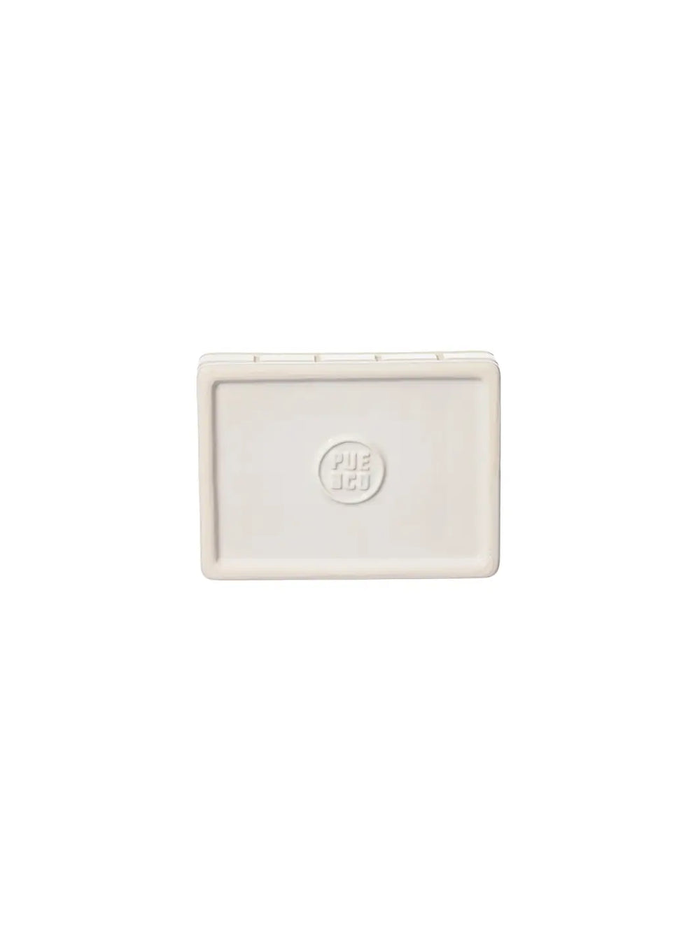 A top-down view showing the smooth, clean underside of the white Ceramic Bath Ensemble / Soap Dish from Puebco, featuring a circular debossed brand logo in the centre | Twentyseven Toronto