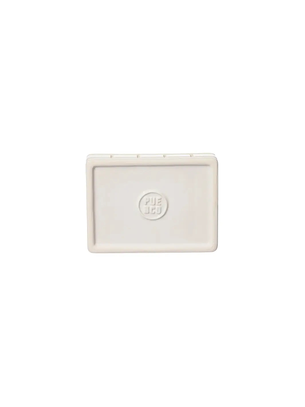 A top-down view showing the smooth, clean underside of the white Ceramic Bath Ensemble / Soap Dish from Puebco, featuring a circular debossed brand logo in the centre | Twentyseven Toronto