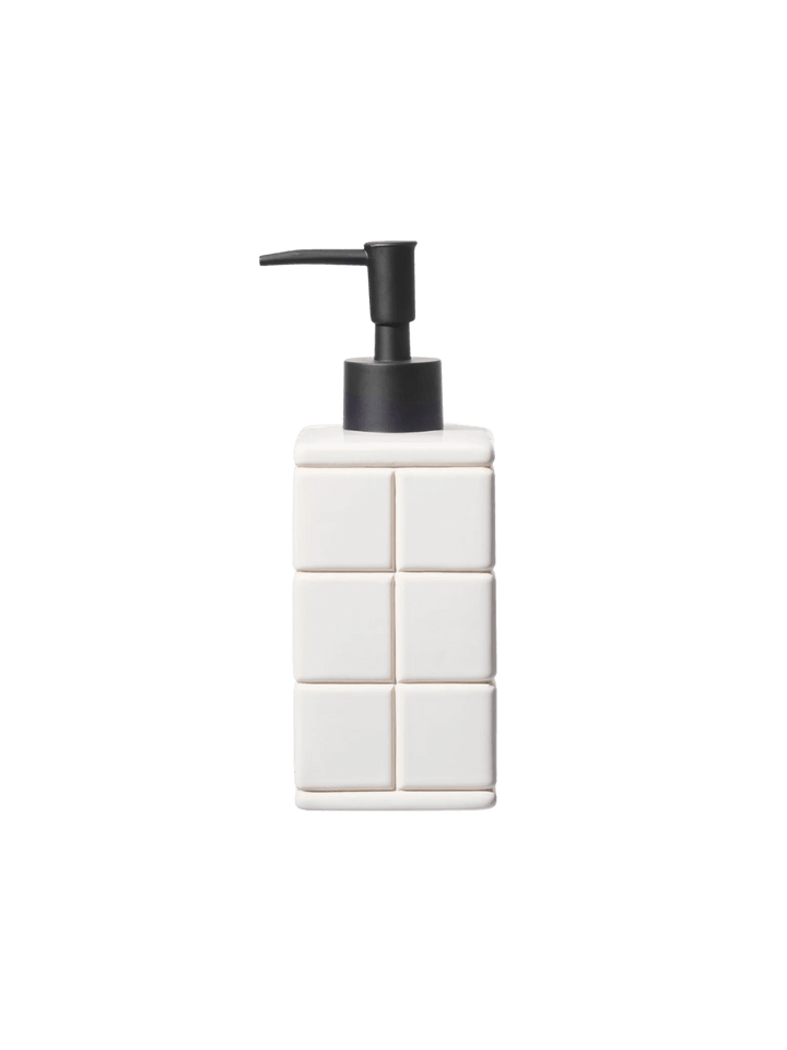 Front-facing product shot of the white Ceramic Bath Ensemble / Soap Dispenser from Puebco, showcasing its raised square tile pattern paired with a contrasting matte black pump | Twentyseven Toronto