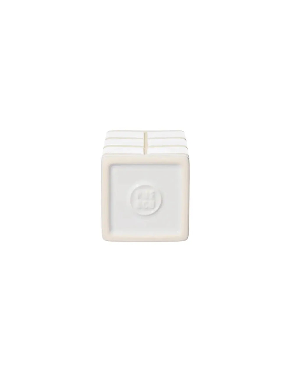 The square underside of the white Ceramic Bath Ensemble / Toothbrush Stand from Puebco, showcasing its clean edges and a circular debossed brand logo in the centre | Twentyseven Toronto