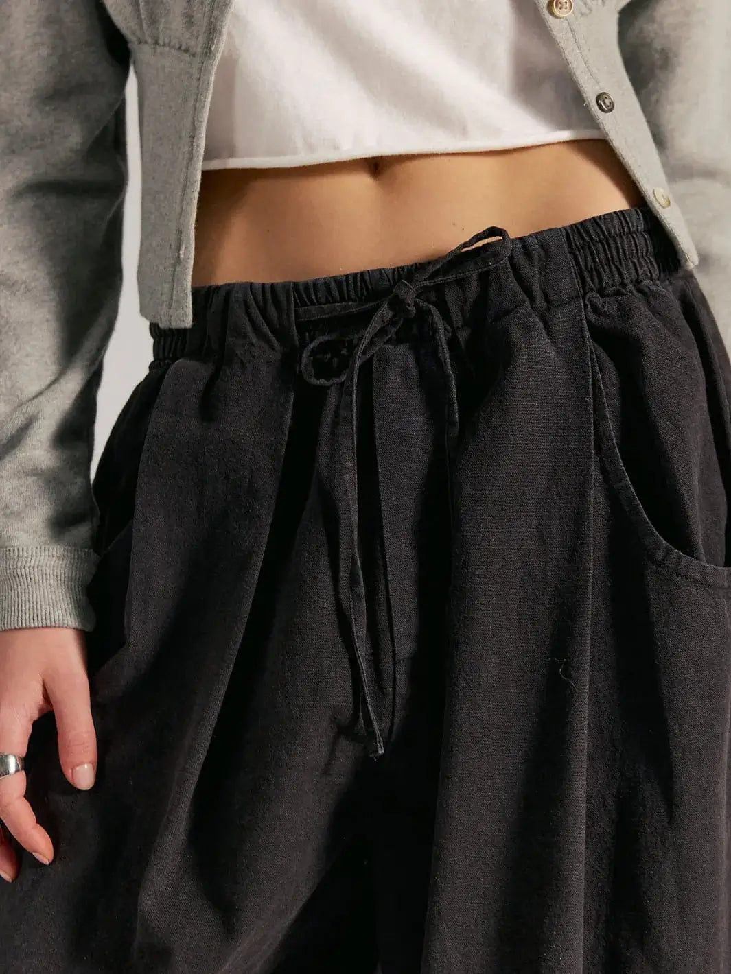 A close-up front view highlights the elastic drawstring waistband and slouchy front pockets of the Free People Chambers Laidback Pull-On Pants in Black | Twentyseven Toronto