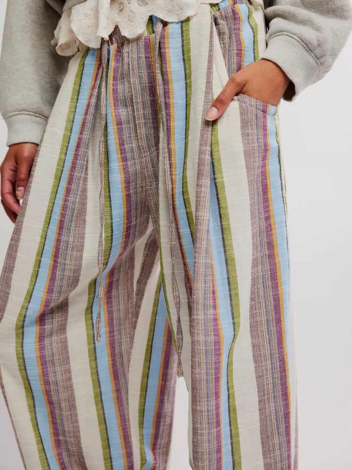 Close up details of 'Chambers Laid Back Stripe Pants' in 'Ivory Combo' with hand in pocket from Free People on a white background | Twentyseven Toronto