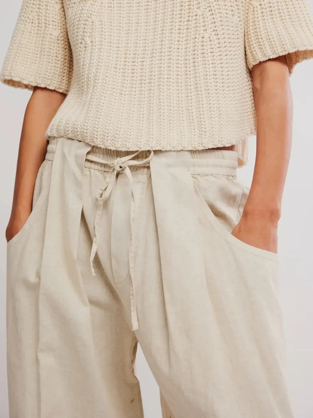 A close-up front view highlights the elastic drawstring waistband and deep slouchy front pockets of the Free People Chambers Laidback Pull-On Pants in Summer Sand | Twentyseven Toronto