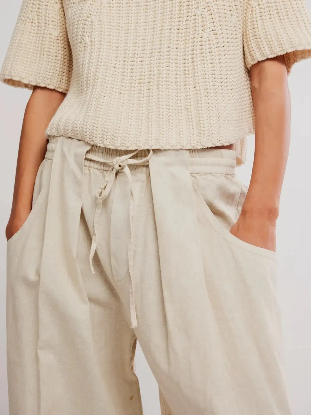 A close-up front view highlights the elastic drawstring waistband and deep slouchy front pockets of the Free People Chambers Laidback Pull-On Pants in Summer Sand | Twentyseven Toronto