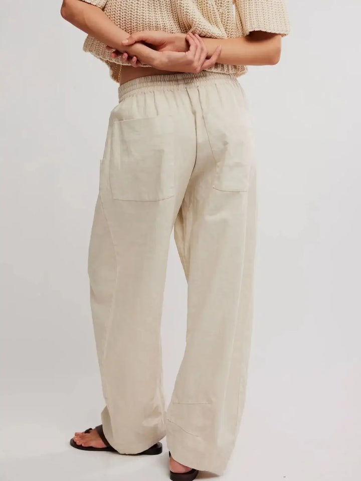 A rear view showcases the back patch pockets and effortless look of the Free People Chambers Laidback Pull-On Pants in Summer Sand | Twentyseven Toronto