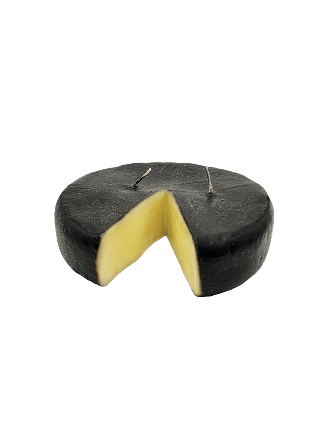 Black rind cheese wheel shaped candle from Cereria Introna with a wedge cut out on a transparent background | Twentyseven Toronto