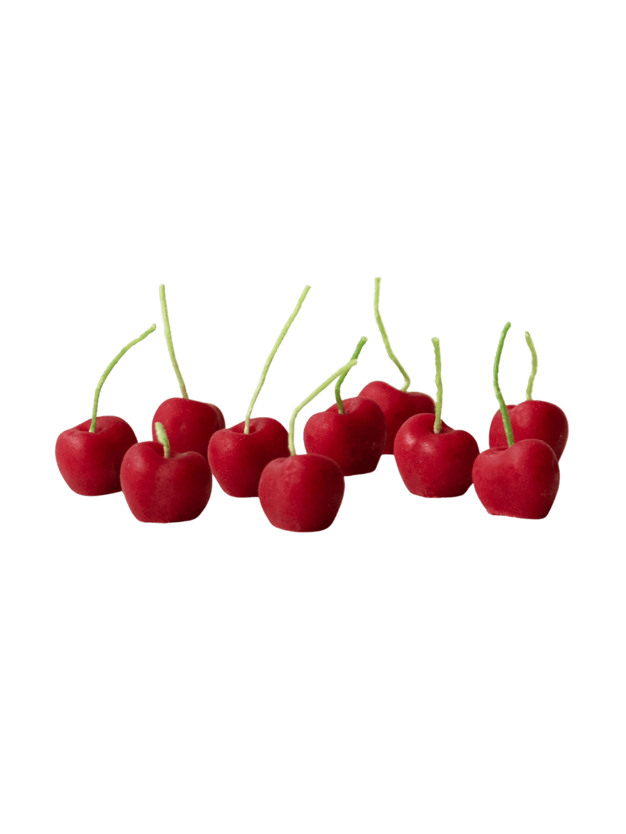 Red cherry-shaped beeswax candles from Happy Organics on a transparent background | Twentyseven Toronto