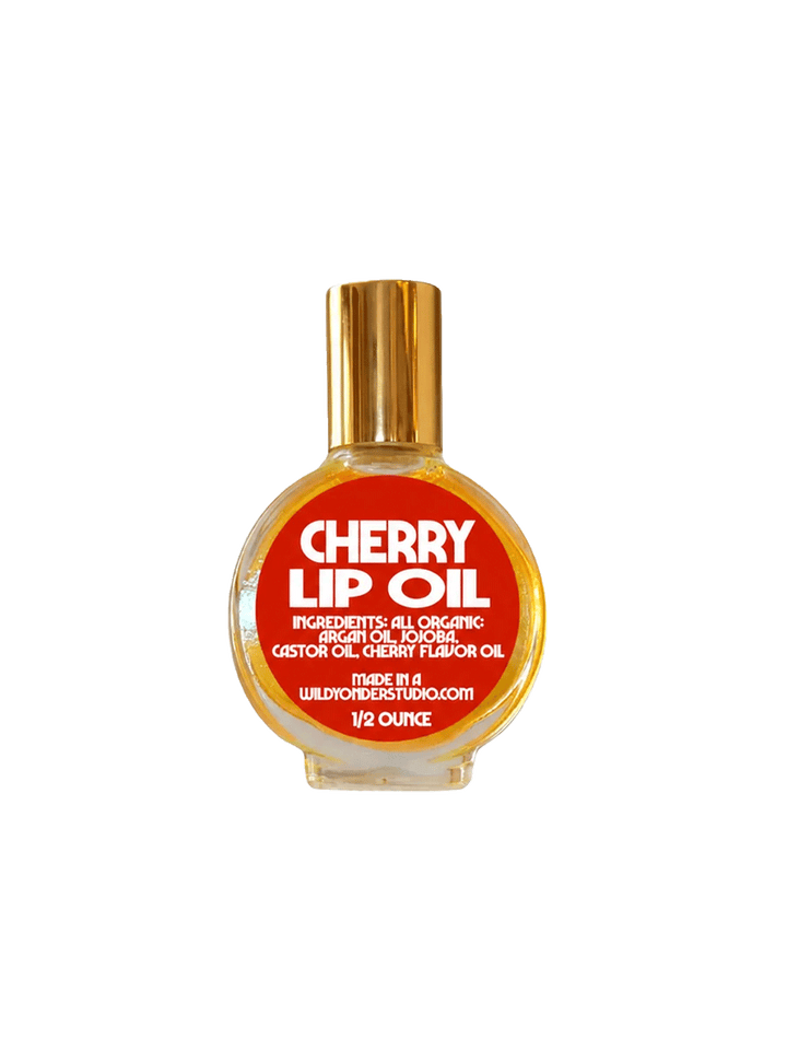 Wild Yonder Studio Cherry Lip Oil in a glass bottle with a red label and gold cap | Twentyseven Toronto