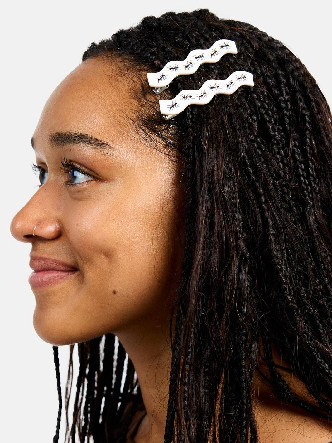 Two white Chunks Ant Clips with black ant print styled in braided hair | Twentyseven Toronto