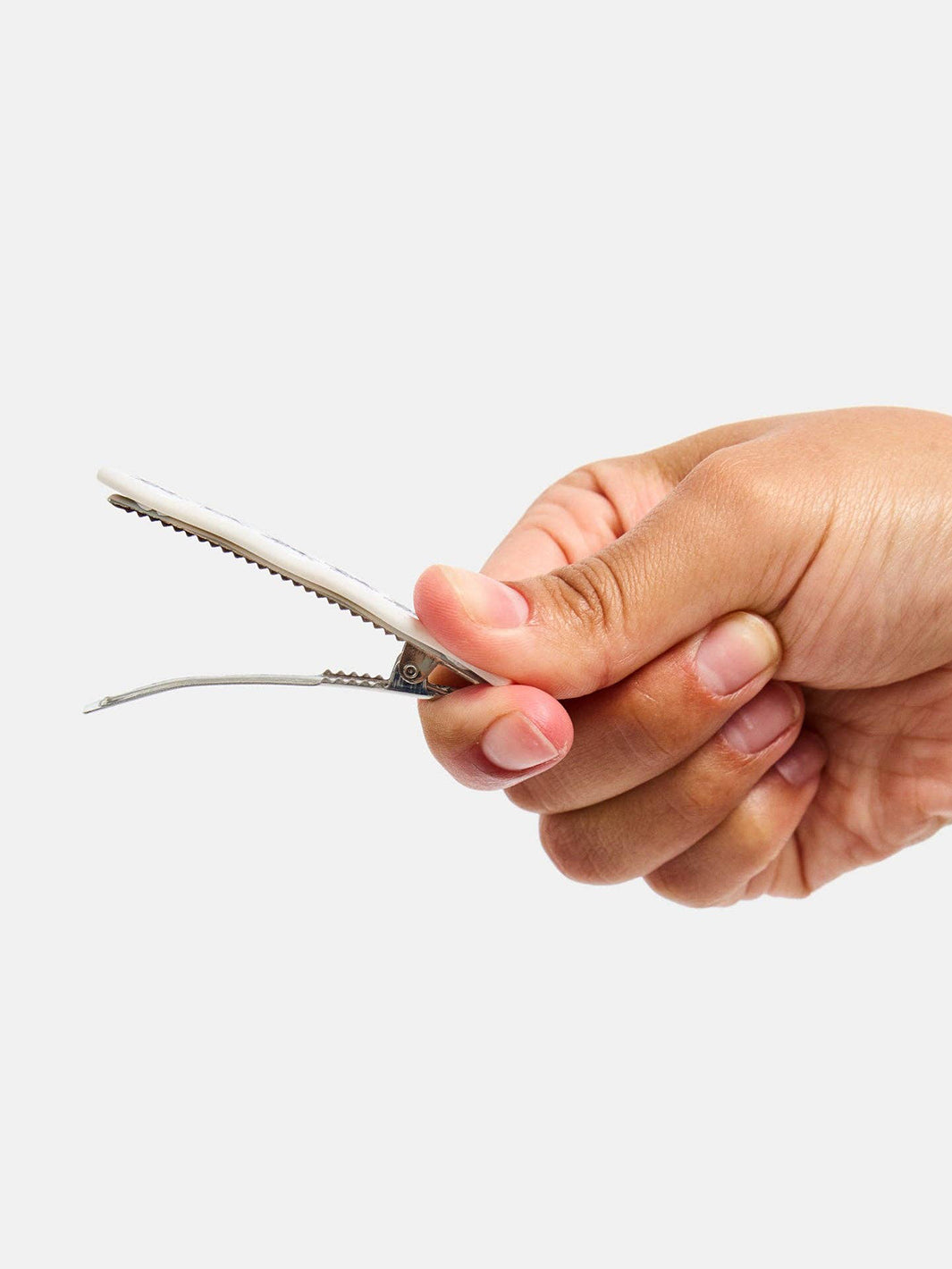 Side view of a white Chunks Ant Clip showing the silver-tone alligator clip and metal teeth | Twentyseven Toronto