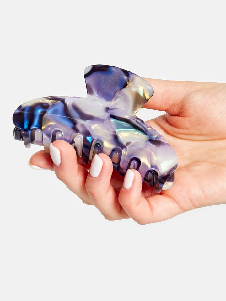 Chunks Baby Dolly Claw in Milk Jelly held in hand to show the claw's size, curved shape, and marbled finish | Twentyseven Toronto