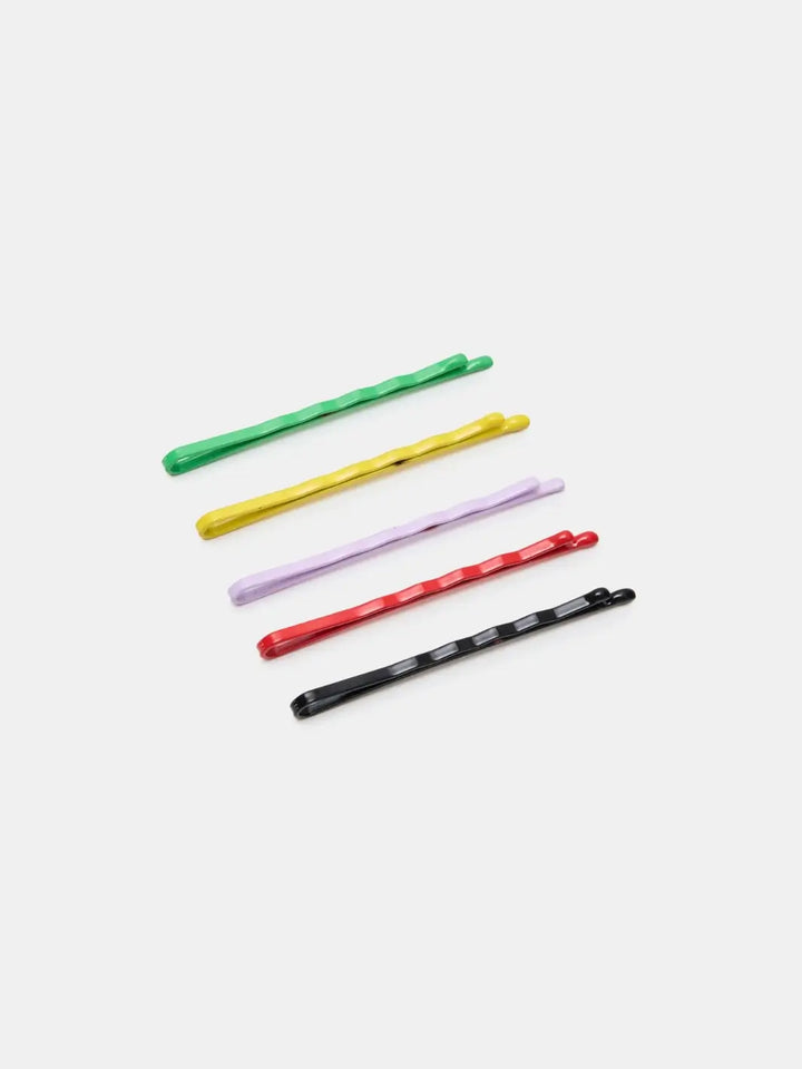 Five colorful bobby pins in green, yellow, lavender, red, and black from the Chunks Hairclips Chunks Bobby Pins collection are arranged diagonally against a gray background | Twentyseven Toronto