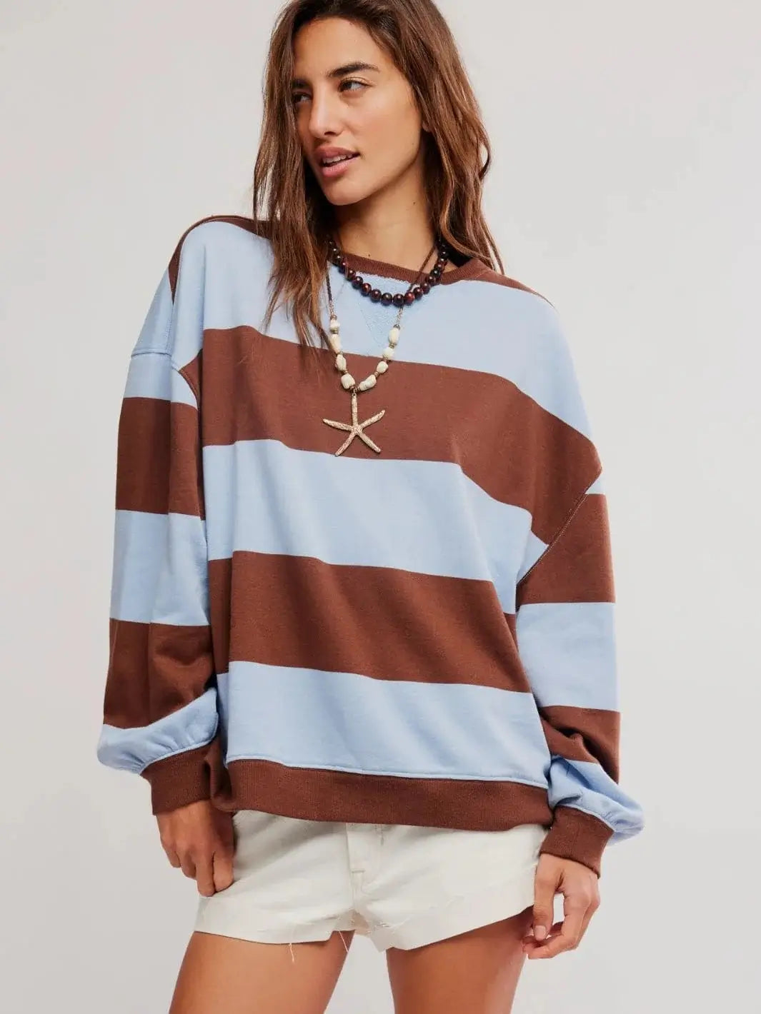 A studio front view showcases the oversized, slouchy fit and broad horizontal stripes of the Free People Classic Stripe Crew Wide in Periwinkle Combo | Twentyseven Toronto