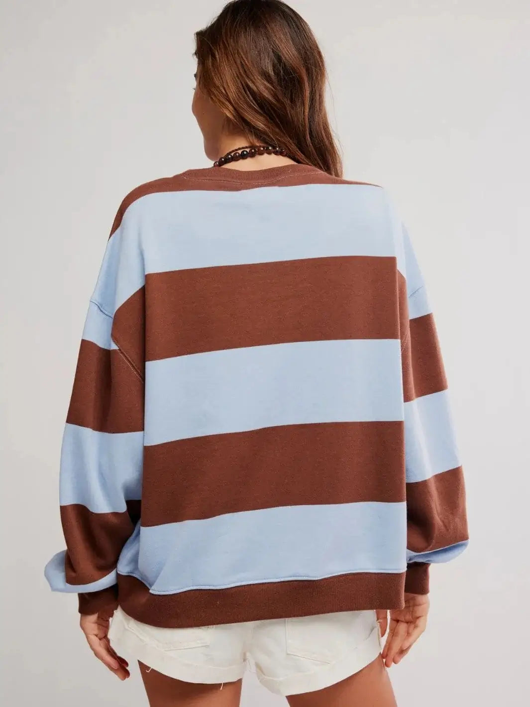 A full rear view emphasizes the generous, wide silhouette and continuous striped pattern of the Free People Classic Stripe Crew Wide in Periwinkle Combo | Twentyseven Toronto