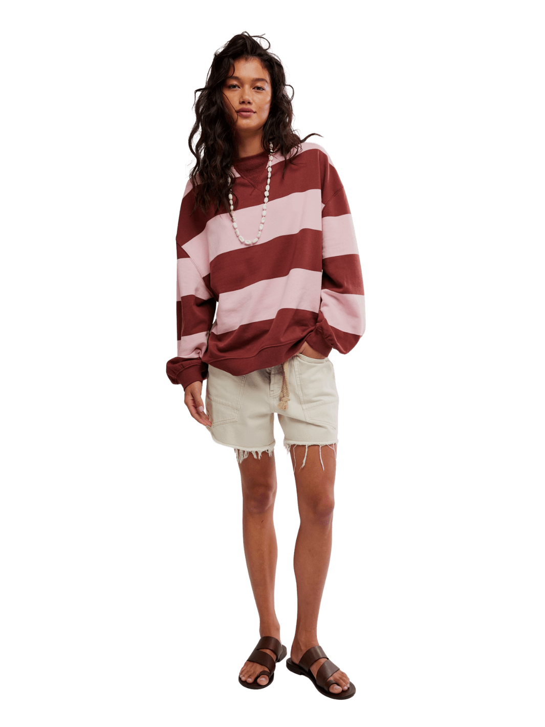 A model pairing the Free People Classic Stripe Crew Wide in Strawberry Wine Combo with cream-colored denim shorts and brown leather sandals | Twentyseven Toronto