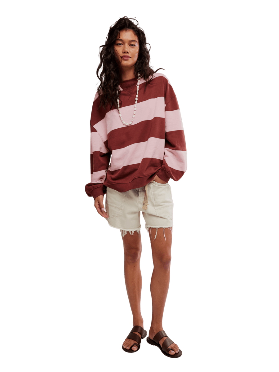 A model pairing the Free People Classic Stripe Crew Wide in Strawberry Wine Combo with cream-colored denim shorts and brown leather sandals | Twentyseven Toronto