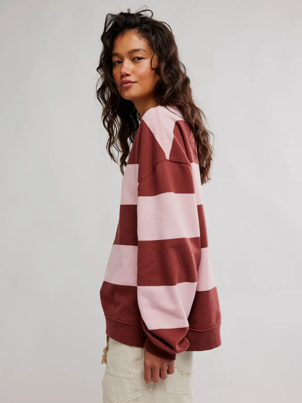 A side profile view shows a woman wearing the oversized Free People Classic Stripe Crew Wide in Strawberry Wine Combo | Twentyseven Toronot