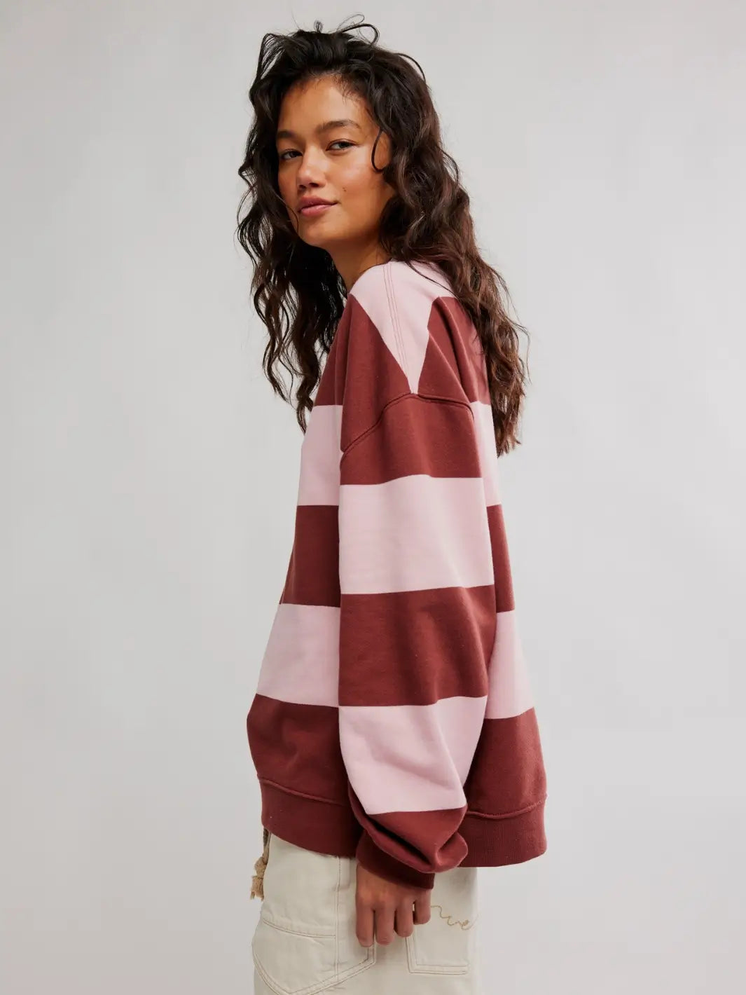 A side profile view shows a woman wearing the oversized Free People Classic Stripe Crew Wide in Strawberry Wine Combo | Twentyseven Toronot