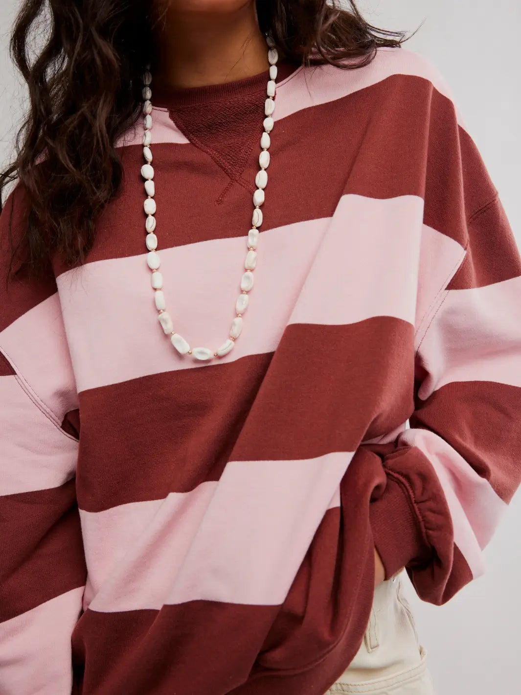 A close-up shot focuses on the V-notch stitching detail at the neckline and the heavy cotton texture of the Free People Classic Stripe Crew Wide in Strawberry Wine Combo | Twentyseven Toronto