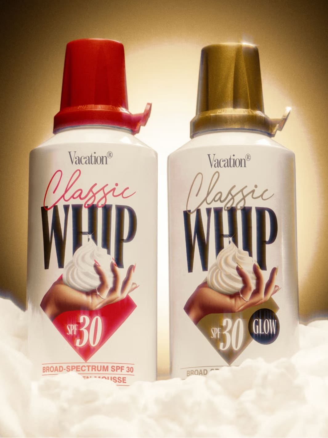 Vacation Inc. Classic Whip Glow SPF 30 | Twentyseven Toronto | Two bottles of 'Vacation Classic Whip' sunscreen with red and gold caps on a white background.