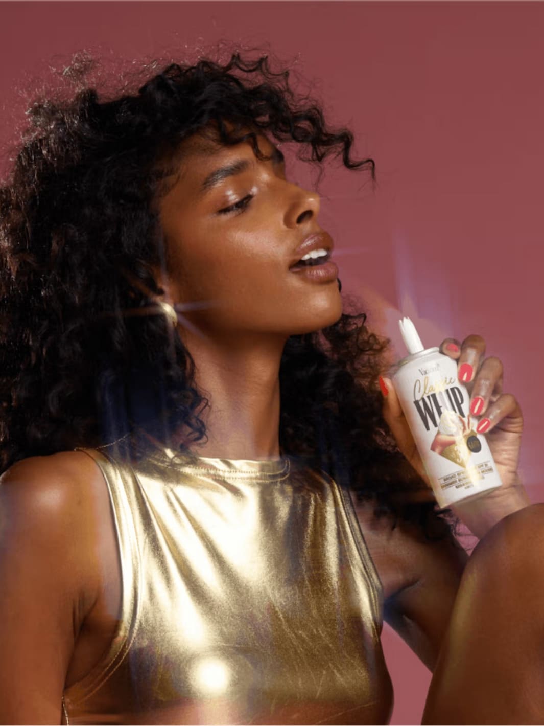 Vacation Inc. Classic Whip Glow SPF 30 | Twentyseven Toronto | Woman holding a can of whipped cream against a pink background
