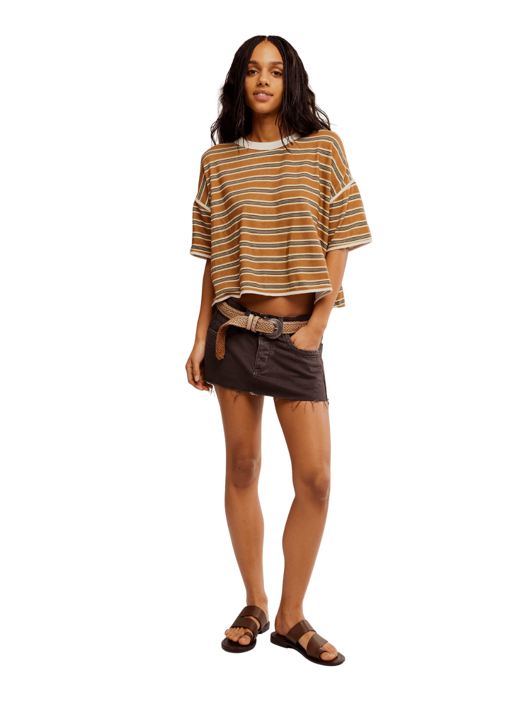 A model dressed in the Free People Clean Rugby Tee in Almond Combo, a brown denim mini skirt, and leather sandals | Twentyseven Toronto