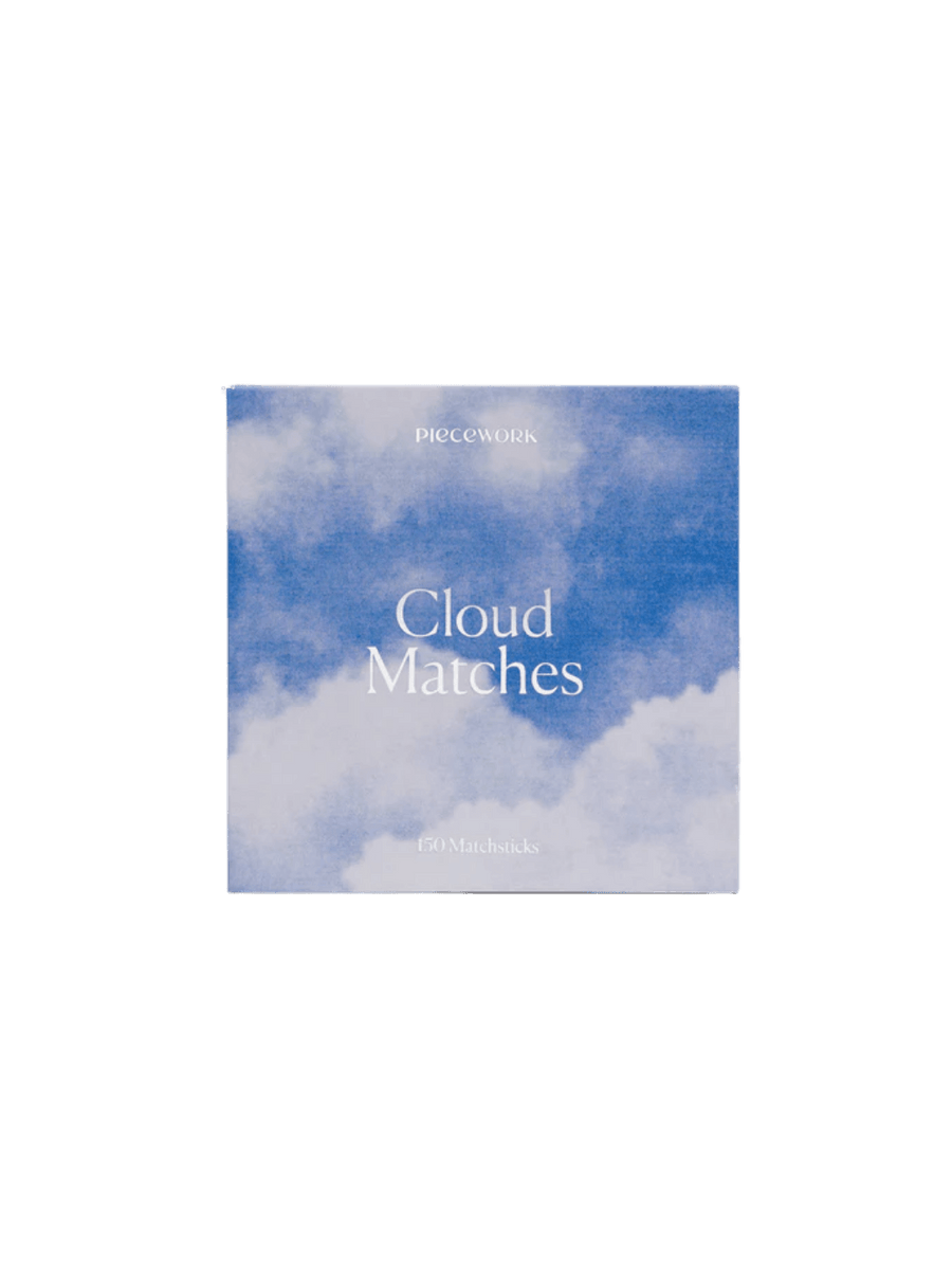 Box of matches with blue cloud design labeled 'Cloud Matches' from Piecework Puzzles on a transparent background | Twentyseven Toronto