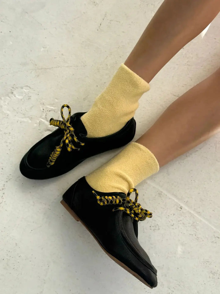 Yellow Cloud Socks in 'Lemon Water' from Le Bon Shoppe styled with black shoes | Twentyseven Toronto