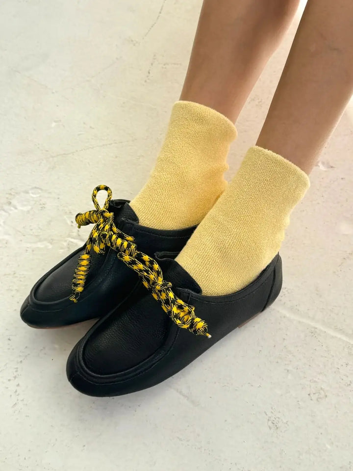 Yellow Cloud Socks in 'Lemon Water' from Le Bon Shoppe styled with black shoes | Twentyseven Toronto