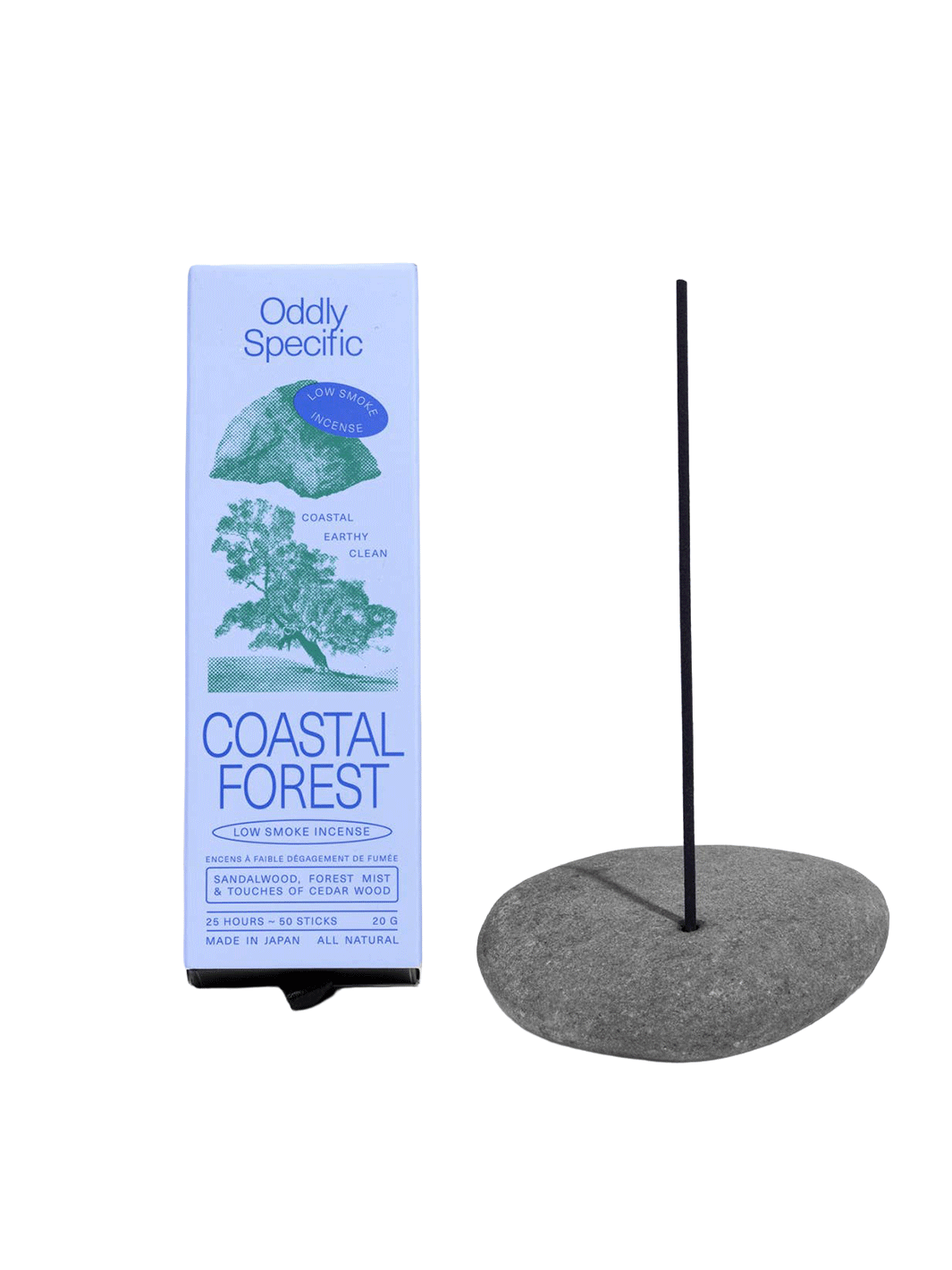 Oddly Specific Coastal Forest Low Smoke Incense in light blue packaging with green tree and coastal illustrations, displayed beside a black incense stick in a grey stone holder | Twentyseven Toronto