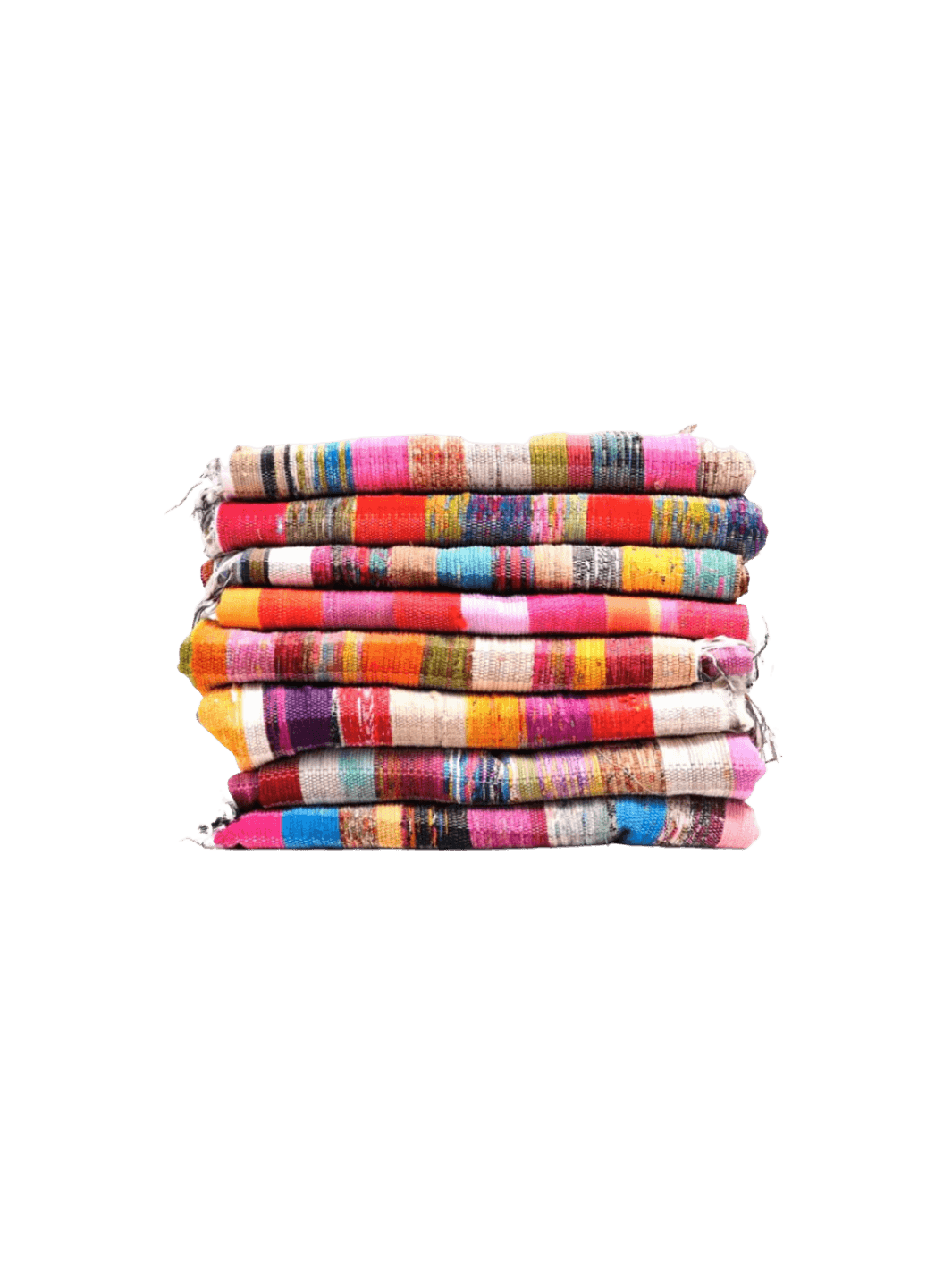 A tall stack of eight Collected Rug from Puebco textiles displays a vibrant array of multi-colored bohemian stripes, rich textures, and rustic, frayed edges | Twentyseven Toronto