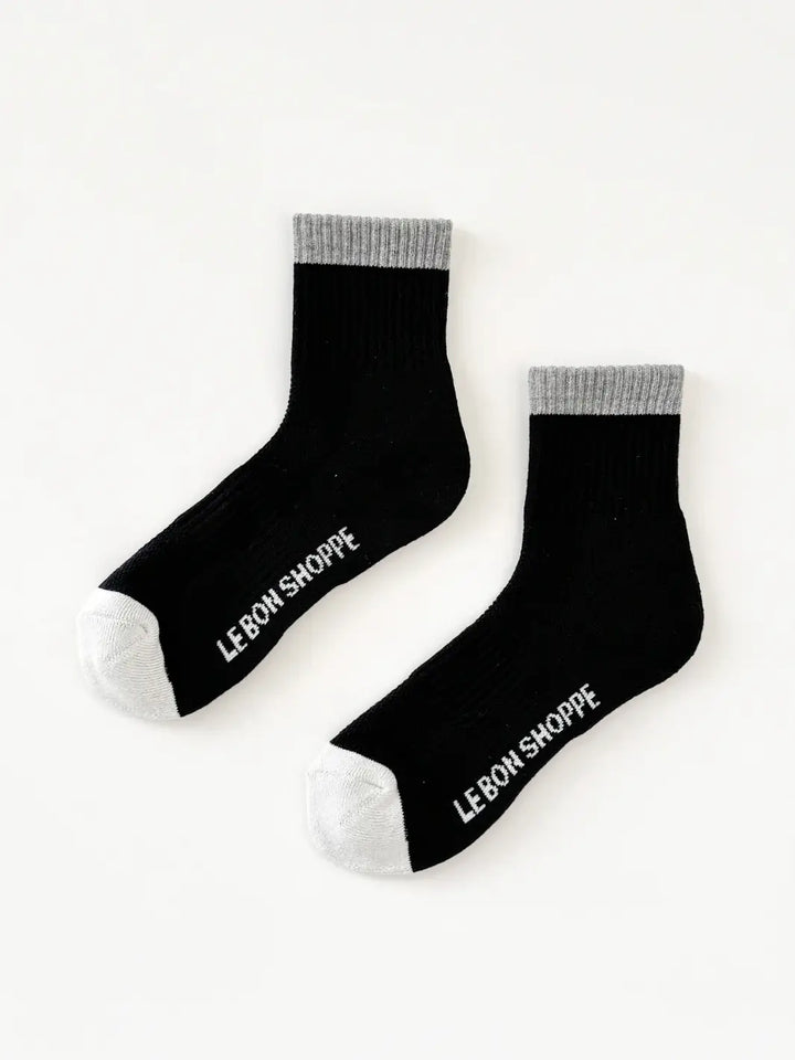 Pair of black 'Color Block' Girlfriend Socks with grey accents and toes in 'Black Grey' style with 'Le Bon Shoppe' lettering on the bottom | Twentyseven Toronto