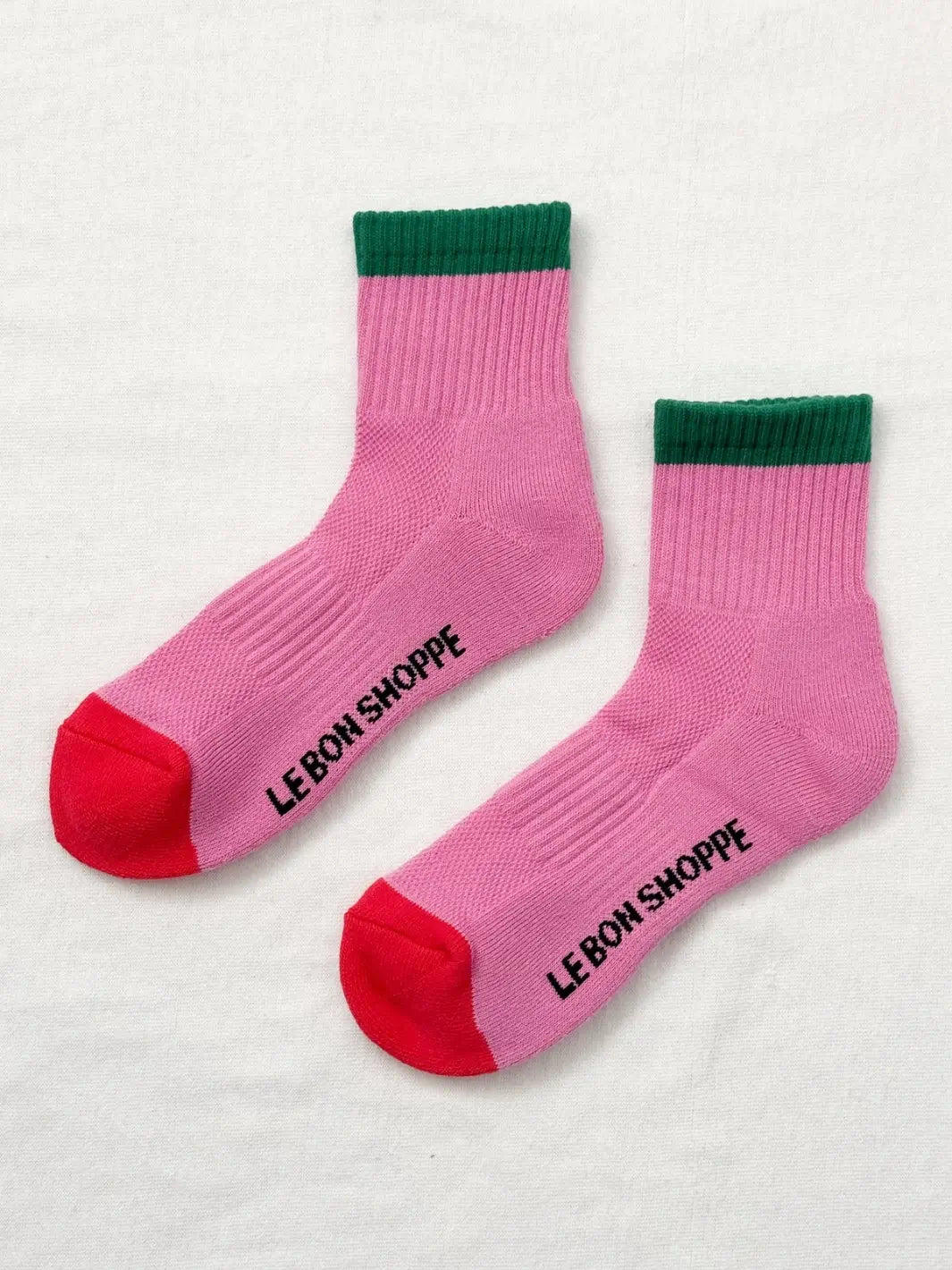 Pair of pink 'Color Block Girlfriend Socks' with green accents and red toes in style 'Rose Green' from Le Bon Shoppe on a white background | Twentyseven Toronto