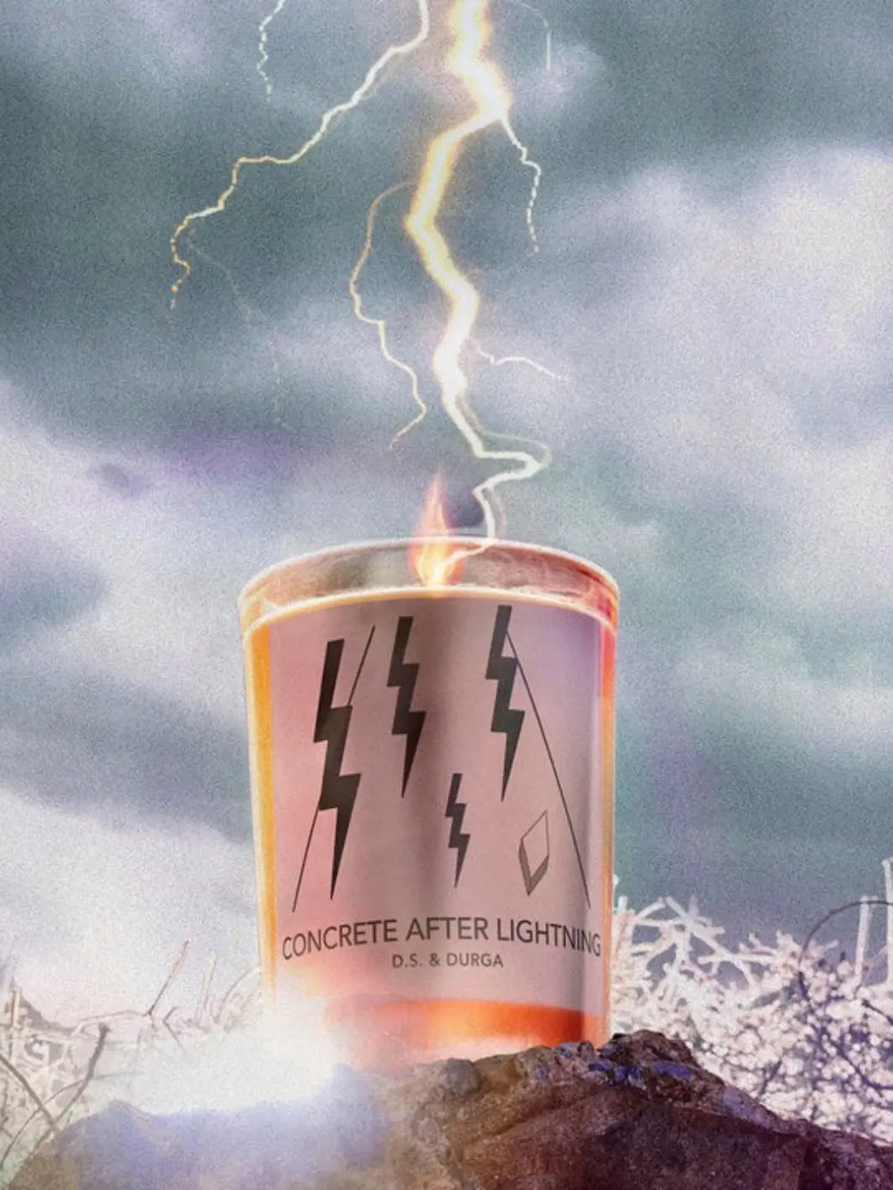 DS&Durga candle labeled 'Concrete After Lightning' with lightning bolts on packaging against a stormy sky | Twentyseven Toronto