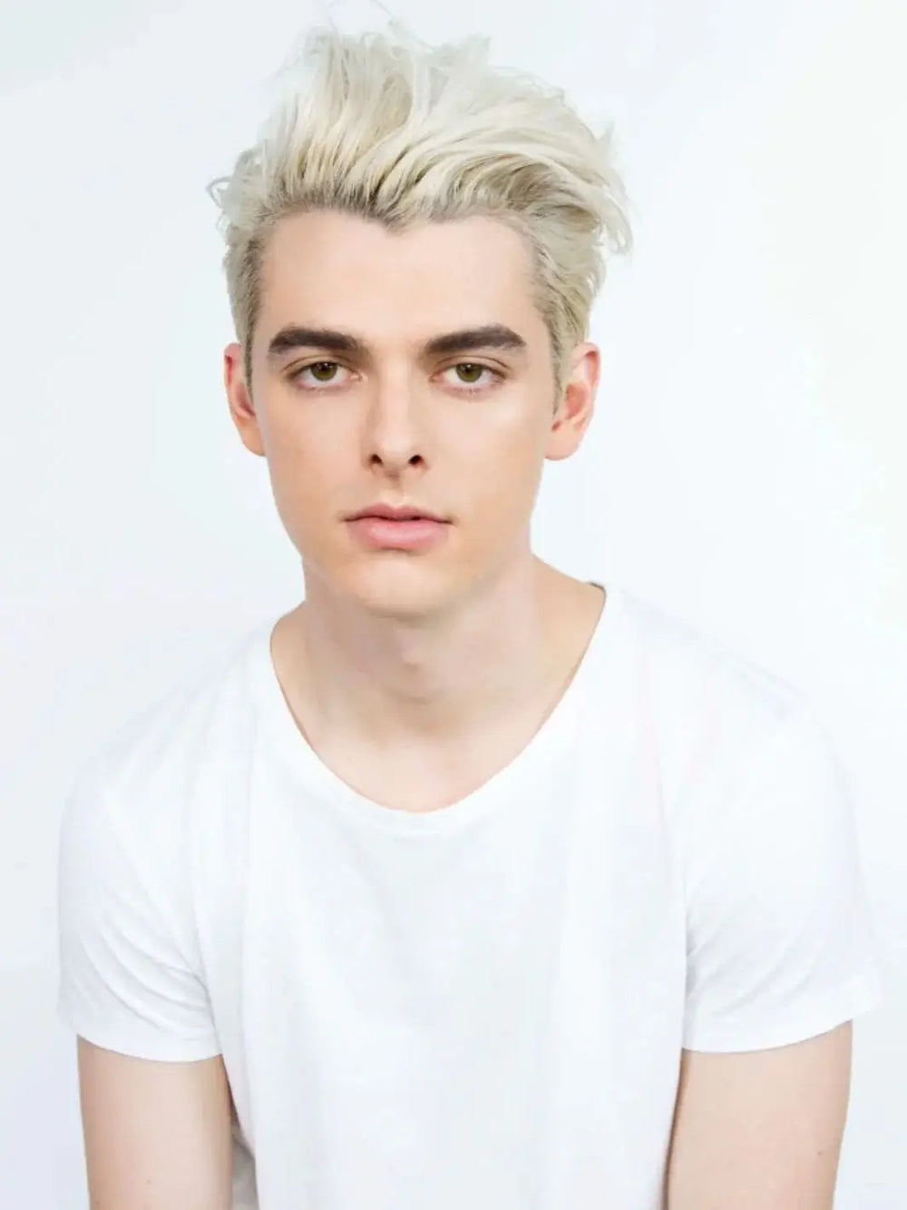 A model showcases a textured, voluminous blonde hairstyle styled with R+Co CONTROL Flexible Control Paste | Twentyseven Toronto