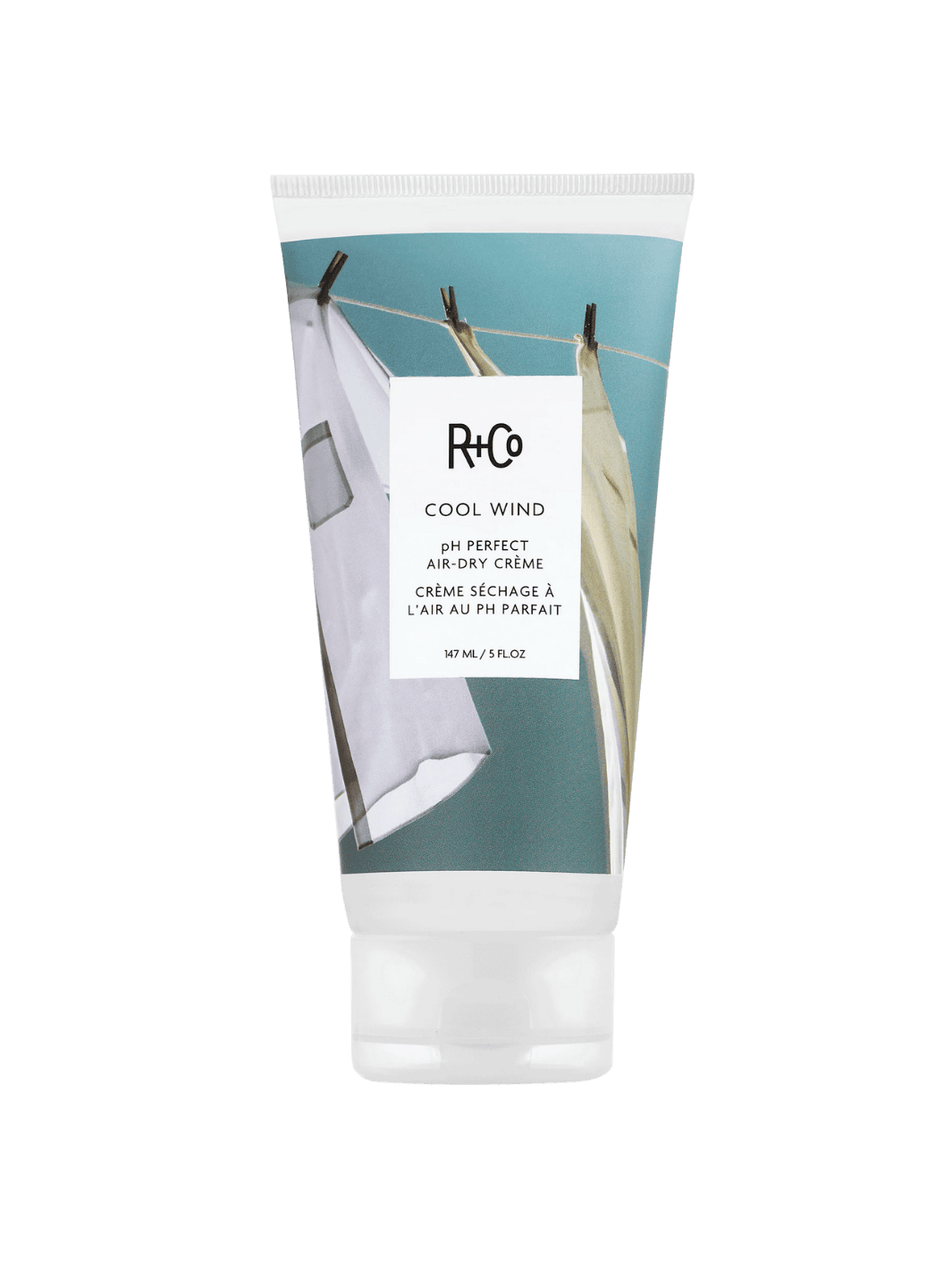 Tube of R+Co 'COOL WIND pH Air Dry Creme' hair product on a transparent background, 147ml | Twentyseven Toronto